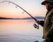 A fisherman demonstrating the perfect overhead cast with a spinning reel and carbon fiber rod.